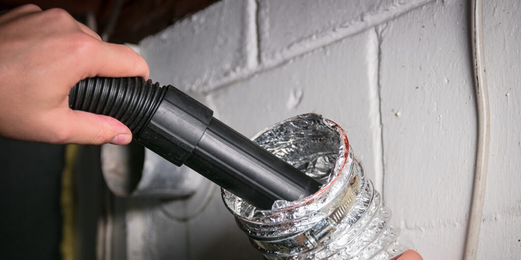 Vacuum,cleaning,a,flexible,aluminum,dryer,vent,hose,,to,remove