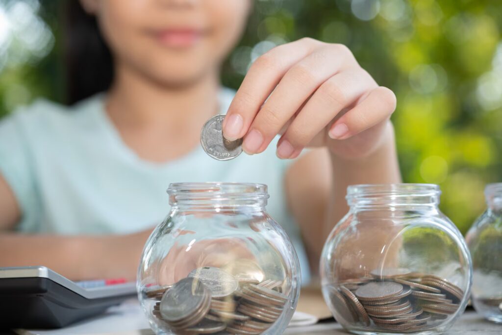 Cute Asian Little Girl Playing With Coins Making Stacks Money Kid Saving Money Into Piggy Bank Into Glass Jar Child Counting His Saved Coins Children Learning About Future Concept 1150 45704