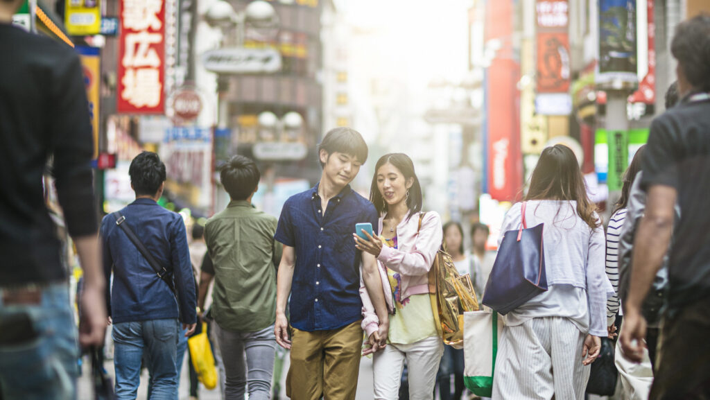 Young Japanese Couple Playing Around The Streets Of Tokyo