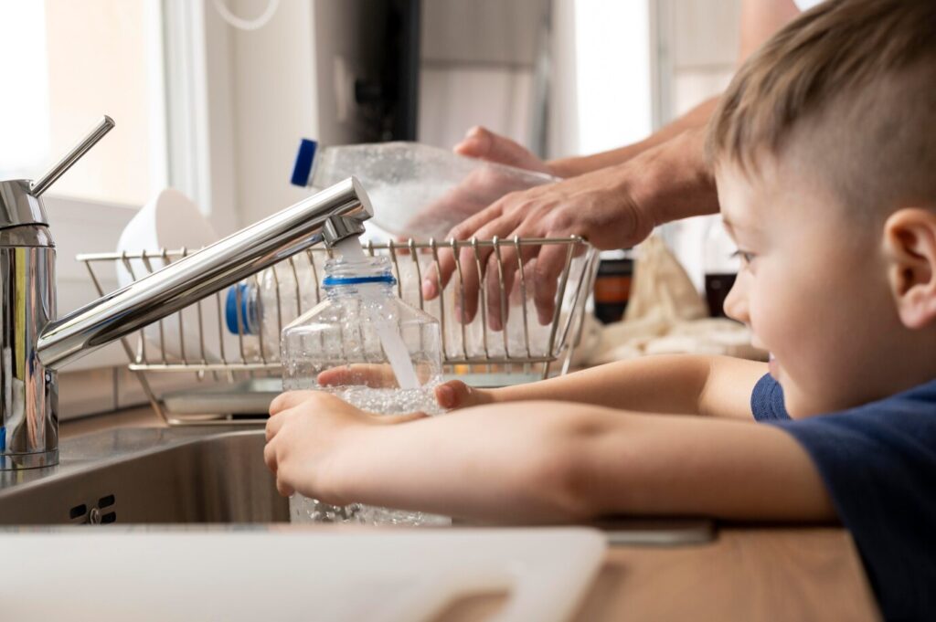 Kid Filling Bottle With Water 23 2148972907