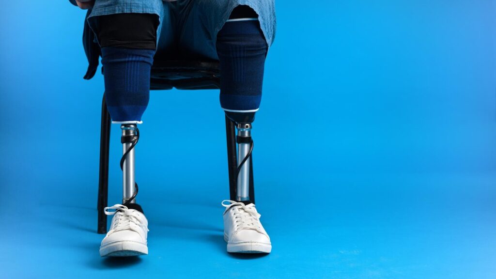 View Man With Prosthetic Legs White Sneakers Sitting Chair Blue Background 1268 21375