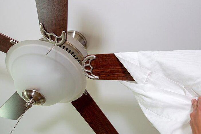 Wrap Your Ceiling Fan Blades With A Pillowcase For Mess Free Dusting