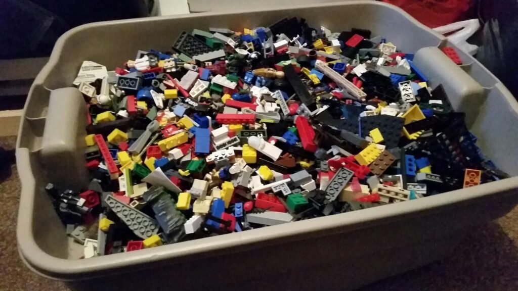 A Plastic Bin Overflowing With Legos