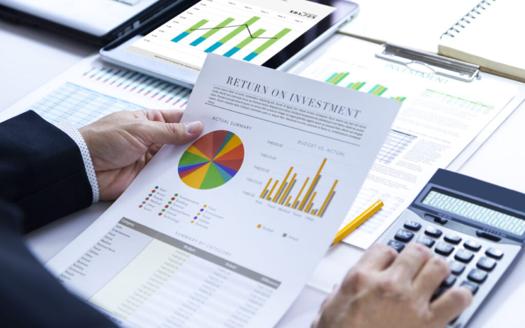 Businessman Is Deeply Reviewing A Financial Report For A Return On Investment Or Investment Risk Analysis.