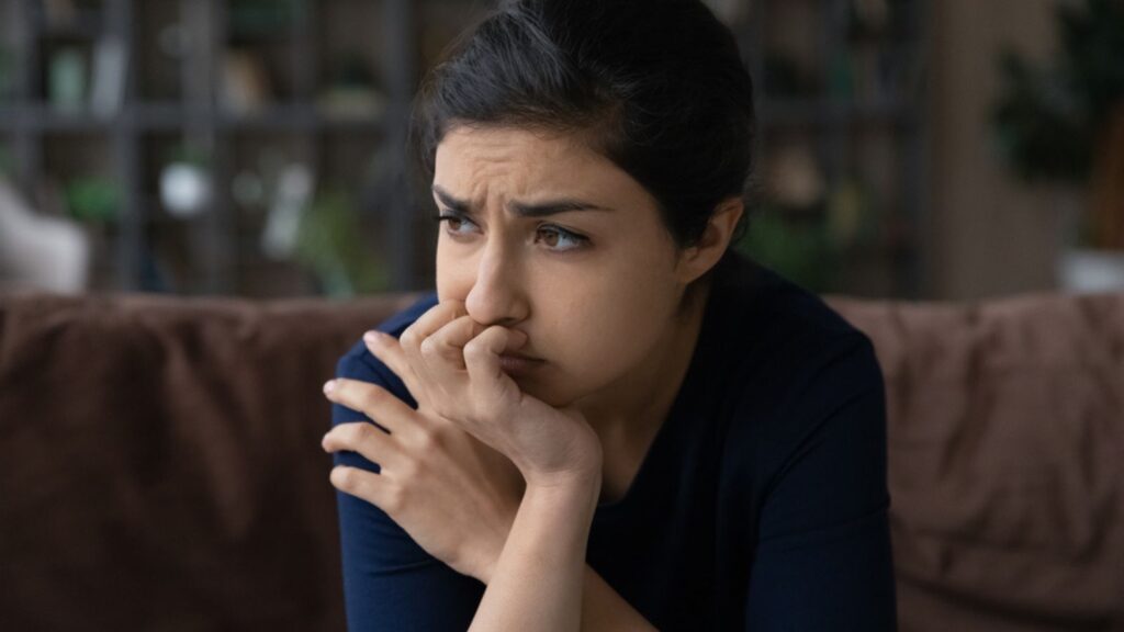 Pessimistic Confused Woman Sit On Couch With Sad Look Hurt With Cheating Of Beloved Man Friend Betrayal Think What To Do. Anxious Having Negative Thoughts