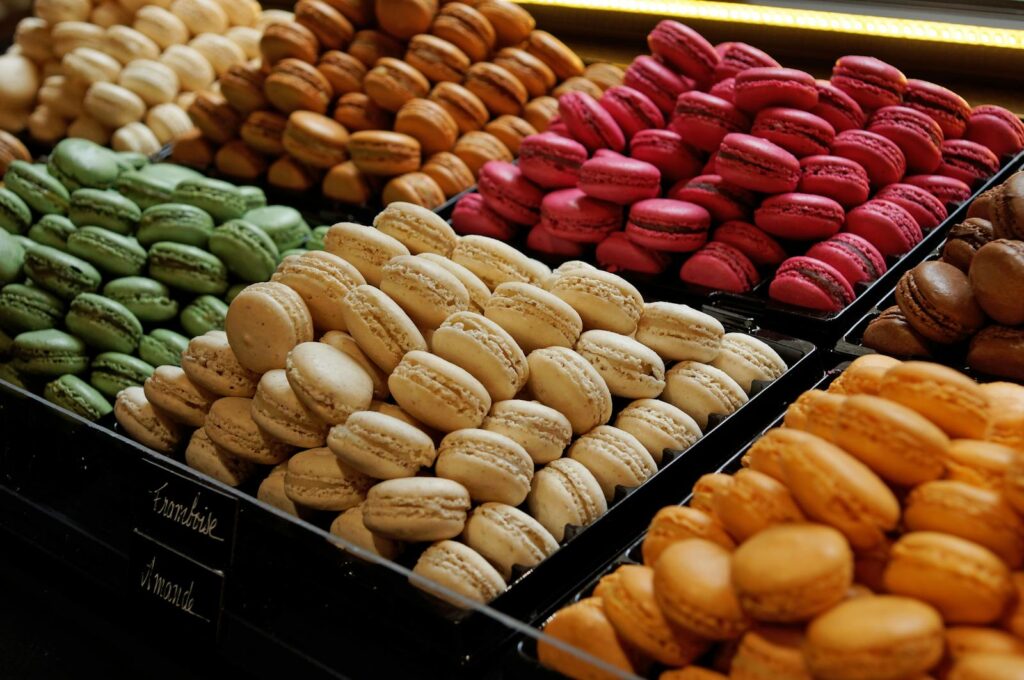 Vibrant assortment of macarons in various flavors and colors neatly stacked on display.