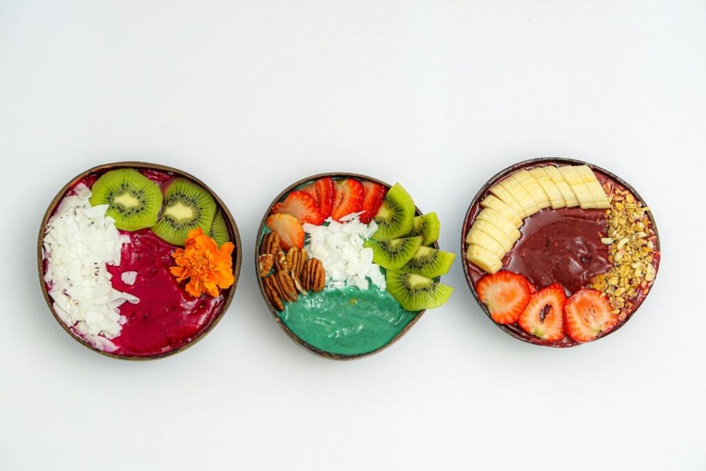 Delicious and colorful smoothie bowls topped with fresh fruits and nuts, capturing the essence of healthy eating.