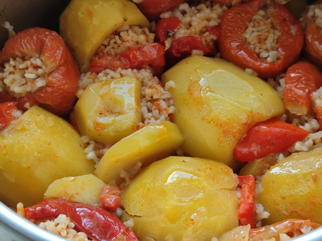 Close-up of traditional stuffed vegetables with rice and peppers.