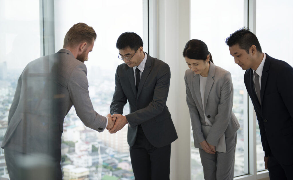 Japanese Businessman People Having A Handshake With A Colleague