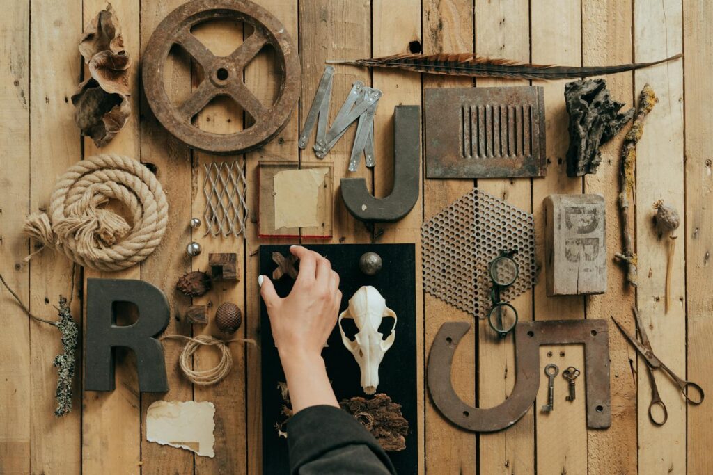 A flat lay of assorted vintage objects on a wooden background, showcasing texture and variety.