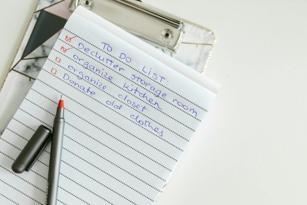 A neatly written to-do list on lined paper with a pen, perfect for organizing tasks.