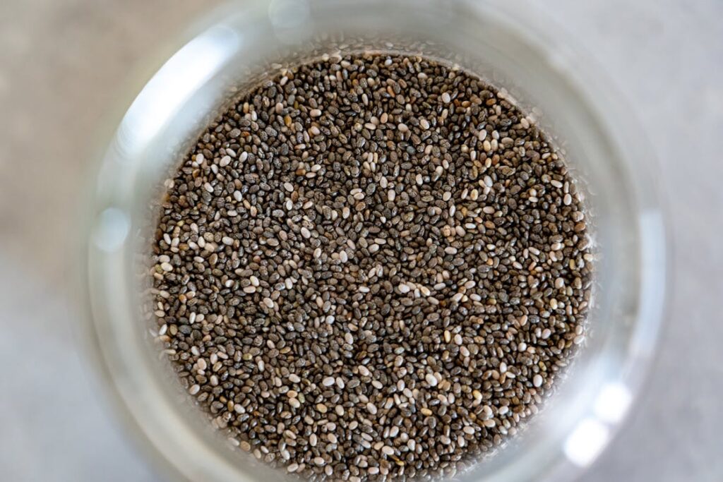 A vibrant bowl of nutrient rich chia seeds is ready to elevate your health with superfood goodness.