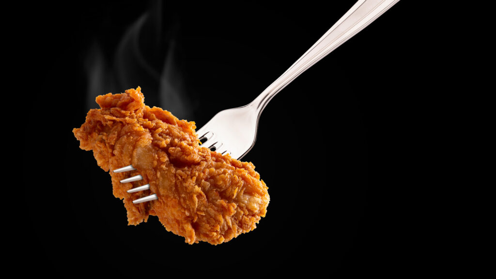 Breaded,fried,chicken,wings,drum,and,flat,on,a,fork