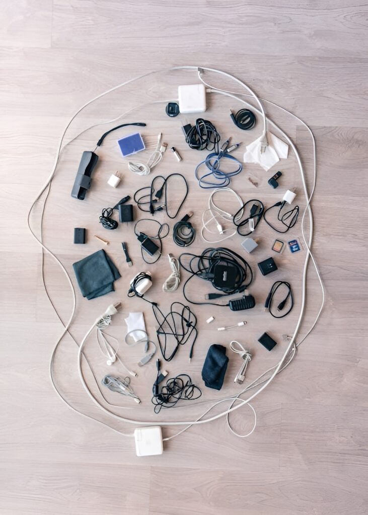 Neatly organized collection of old electronics and carefully sorted cables