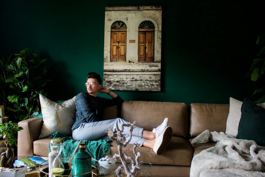 man sitting on sofa in room
