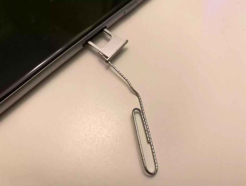 Using A Paperclip To Eject A Phone Sim Tray