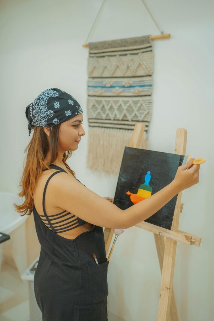 Woman joyfully paints on a canvas