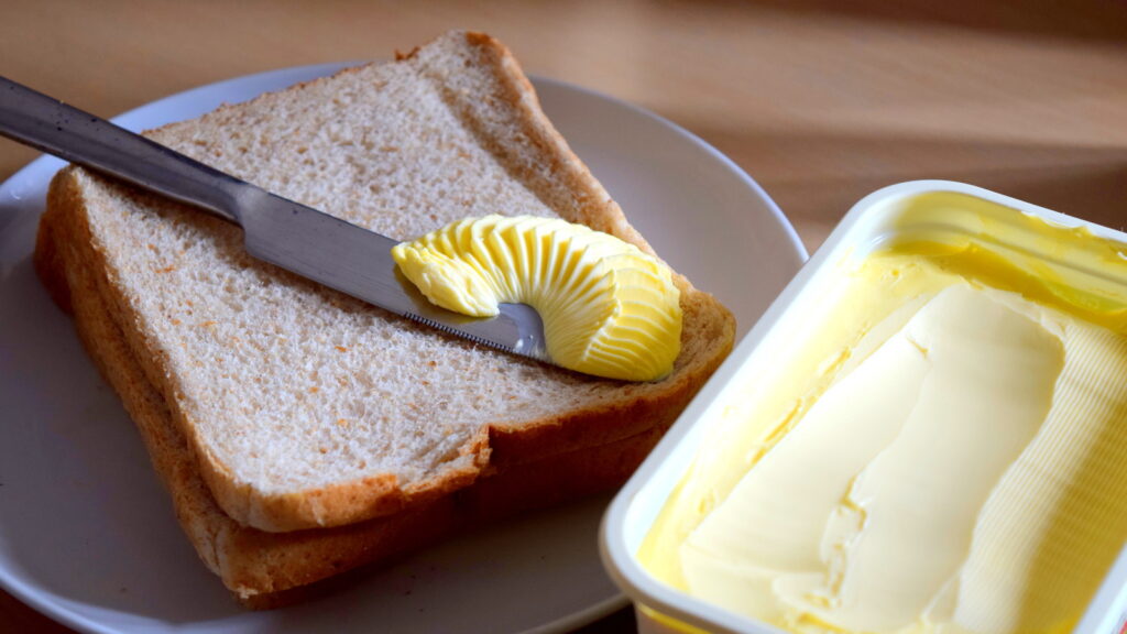 Spreading Margarine Butter Onto Bread