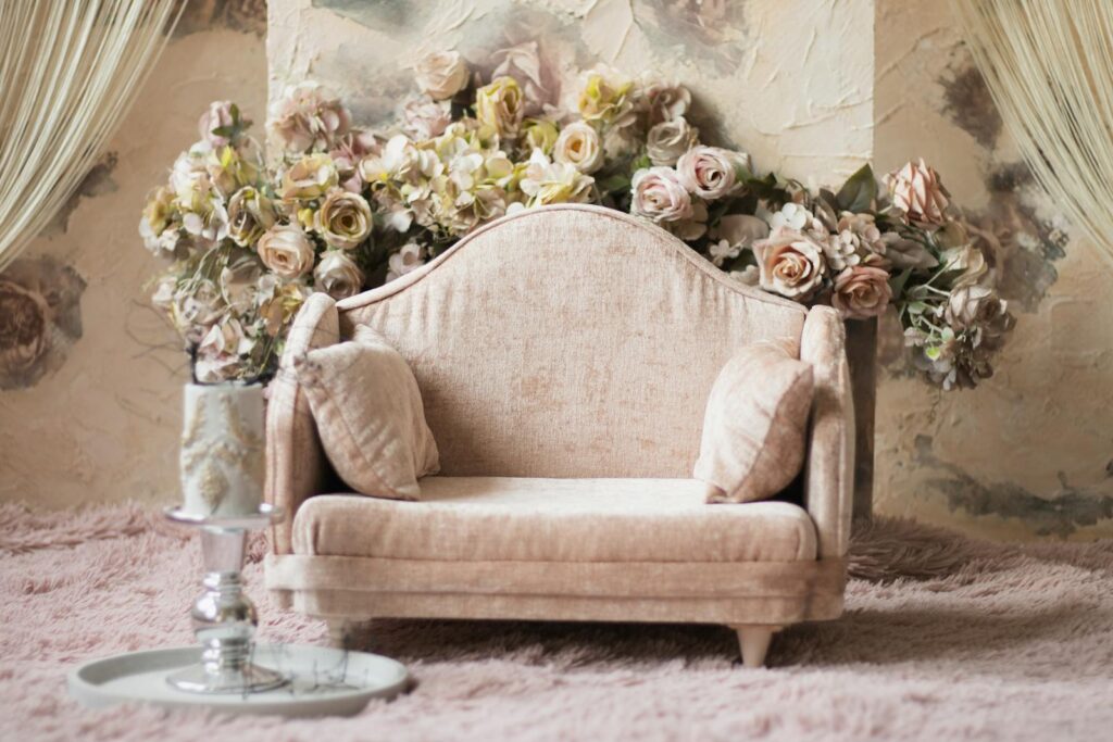 A vintage sofa with a floral backdrop exudes elegance and charm, perfect for interior inspiration.