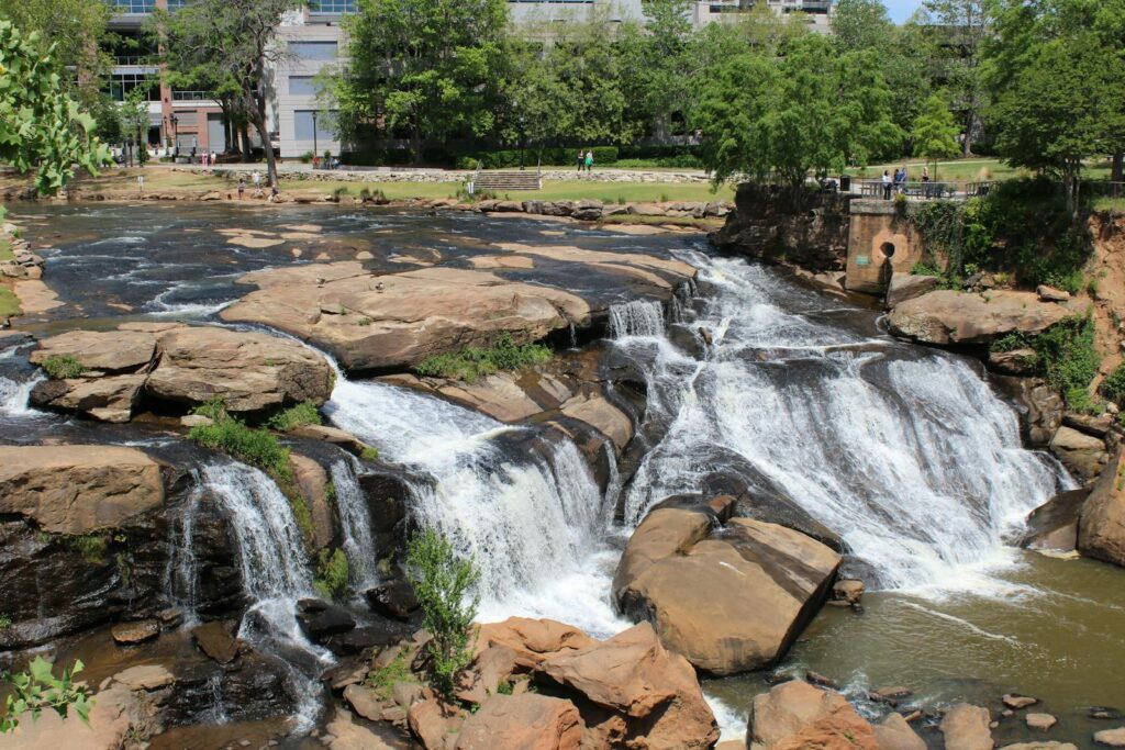Stunning waterfall in Falls Park on the Reedy, Greenville, South Carolina, showcasing natural beauty and architecture.