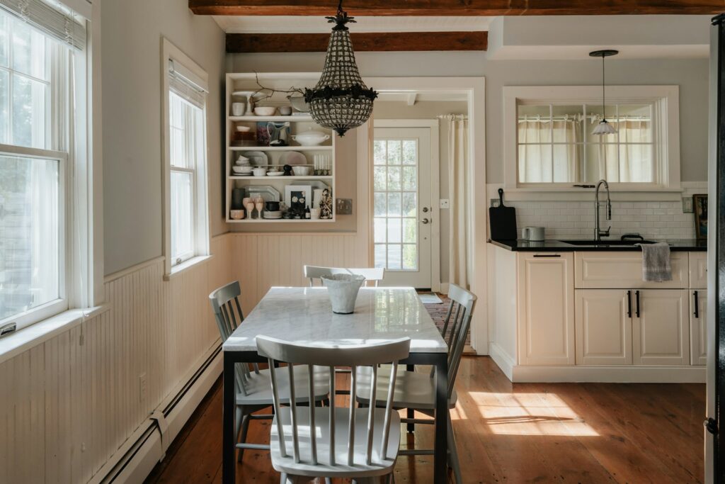 A kitchen with a table and chairs in it