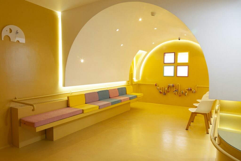 a room with yellow walls and a bench