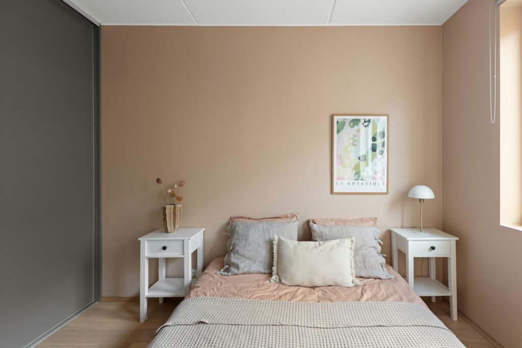 A bed sitting in a bedroom next to a window