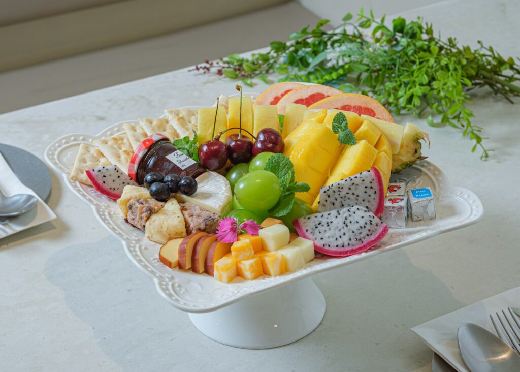 a platter of fruit and cheese on a table