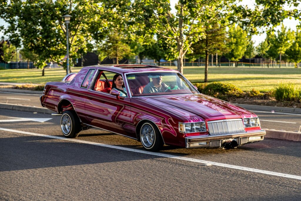 red chevrolet camaro on road during daytime