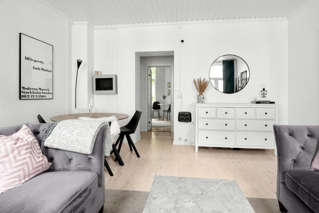 A living room filled with furniture and a mirror