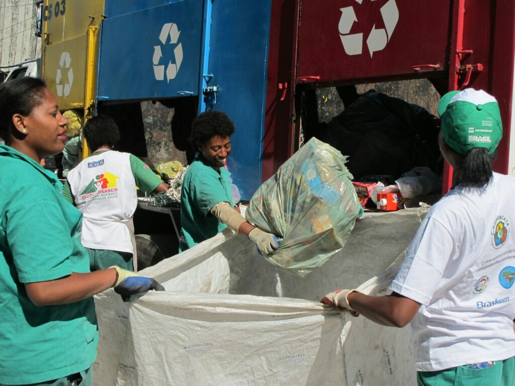 group of people sorting recycled bins