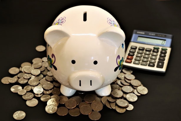 Piggy bank coins and calculator