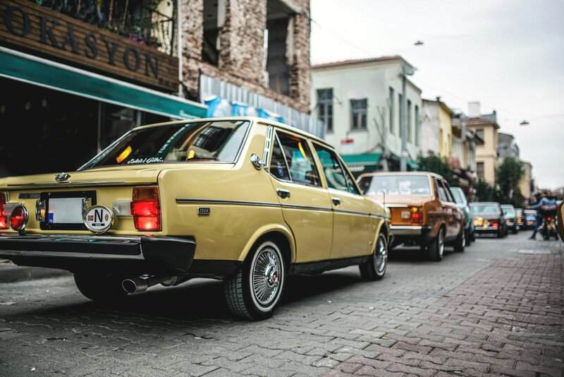 a yellow car parked on the side of the road