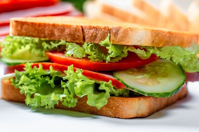 Sandwich with ham cheese tomatoes lettuce and toasted bread