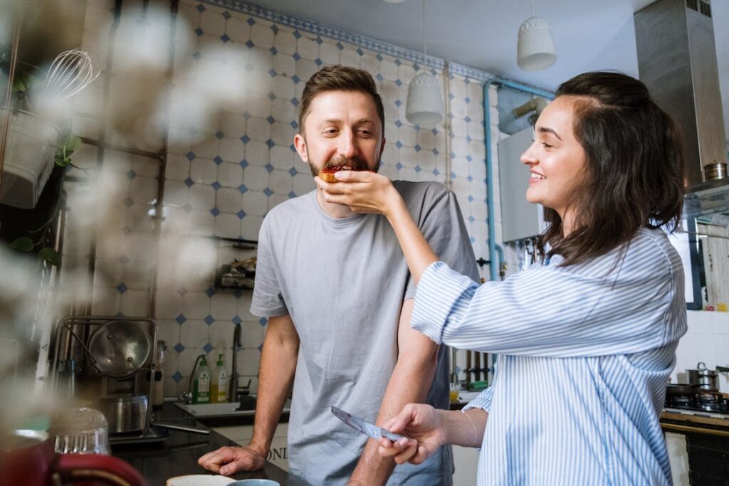 Smiling couple calmly discusses solutions at their kitchen table