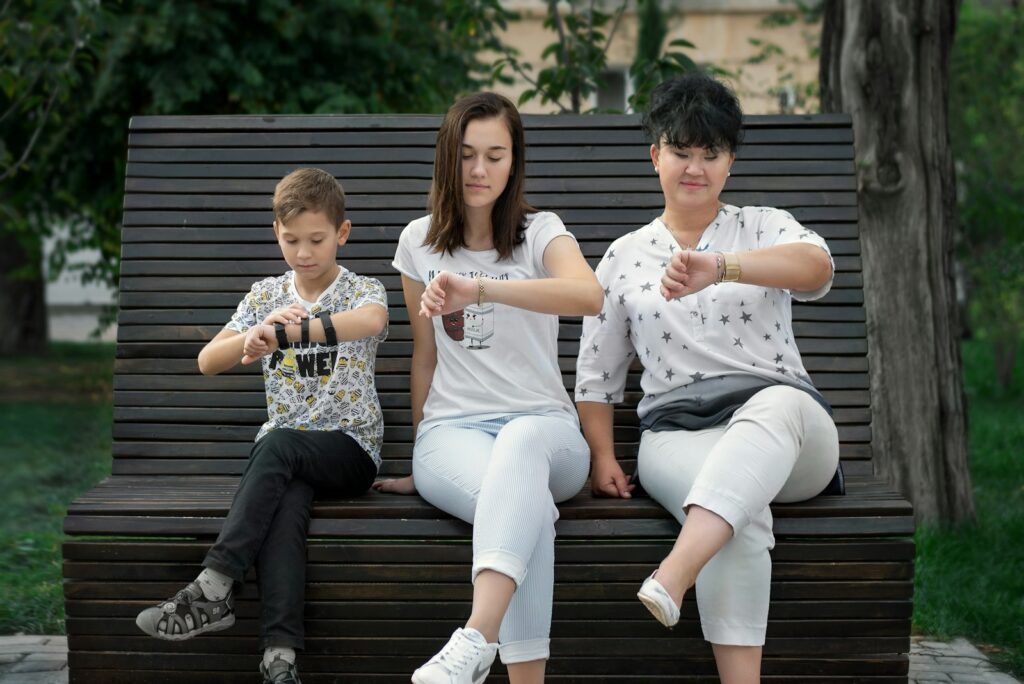 man and woman sitting on brown wooden bench