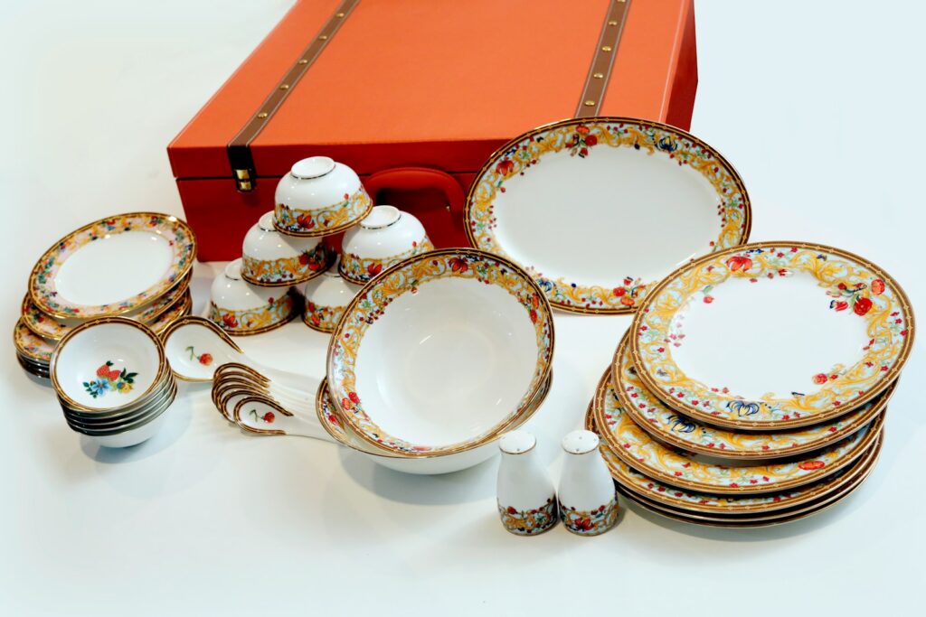 white and blue floral ceramic plate on red table