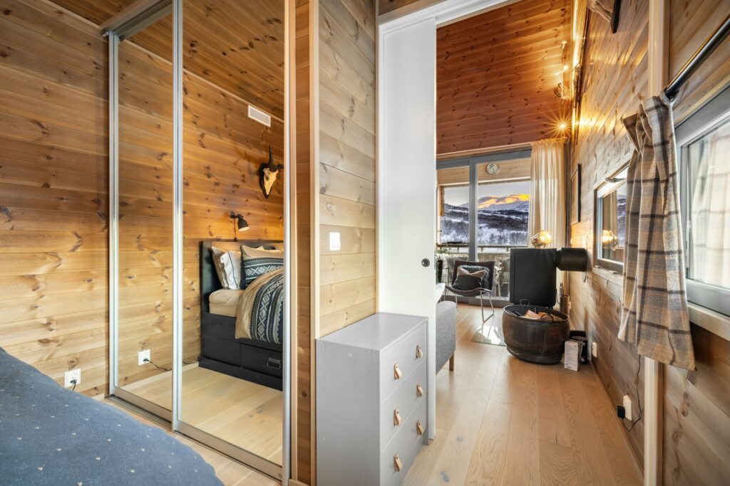 A bedroom with wooden walls and a bed