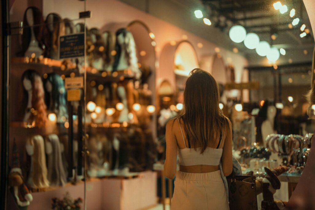 a woman looking at a display of clothing