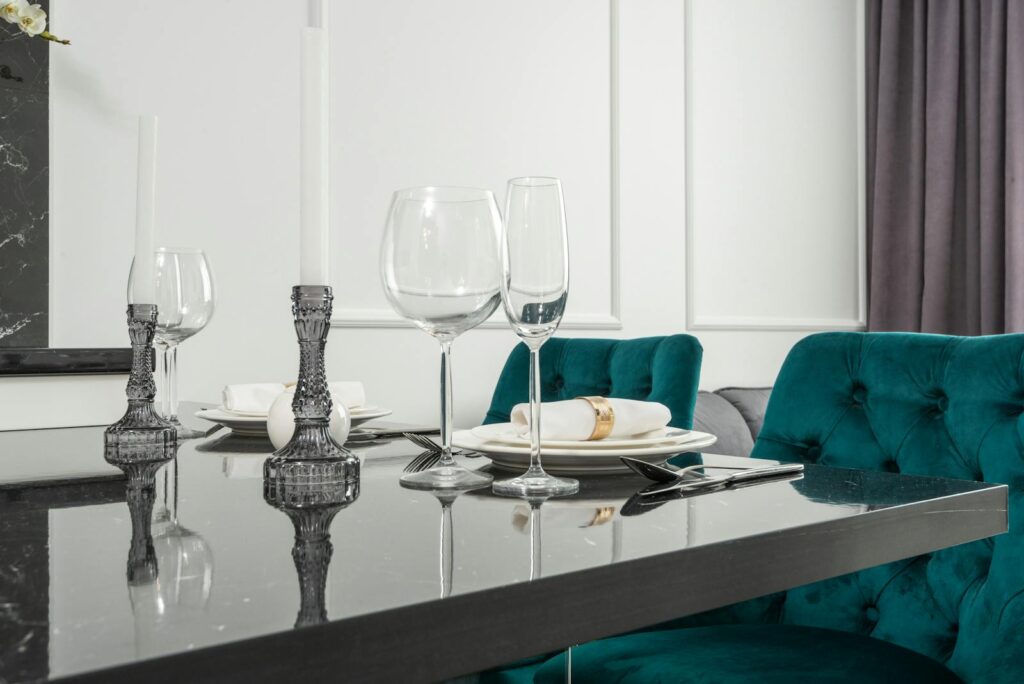 Stylishly set dining table with glassware and candlesticks, perfect for a refined dinner setting.