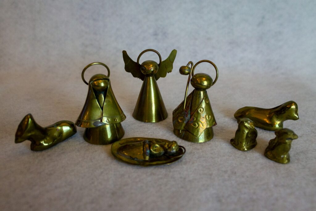 a group of brass figurines sitting on top of a white surface